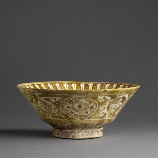 Bowl with a face, foliate scrolls and an inscription