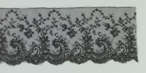 Band of machine-made lace with rose sprigs between C-scrolls along the lower edge