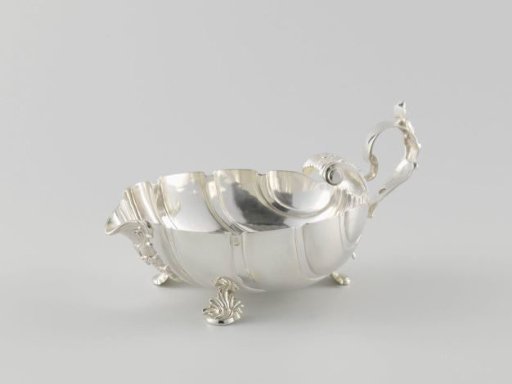 Sauce boat in shell shape with three feet and handle