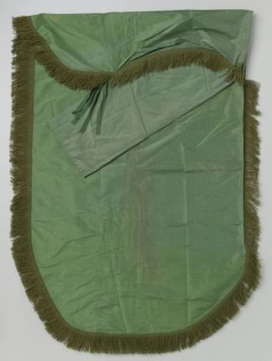 Green silk coverlet with woolen fringe