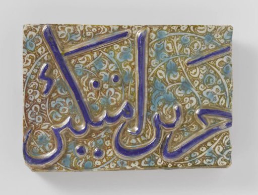 Rectangular tile with an inscription and foliate scrolls