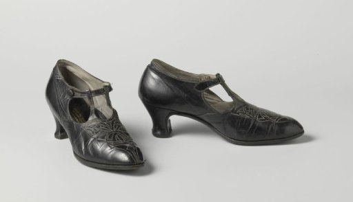 Shoe of black calf(?) leather with a strap fastening on the instep and white cotton embroidery on the forepart