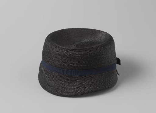 Trotteur of Navy Blue Straw with Straight Crown and Drooping Brim, Decorated with Blue Grosgrain and Flat Bow at the Back Center
