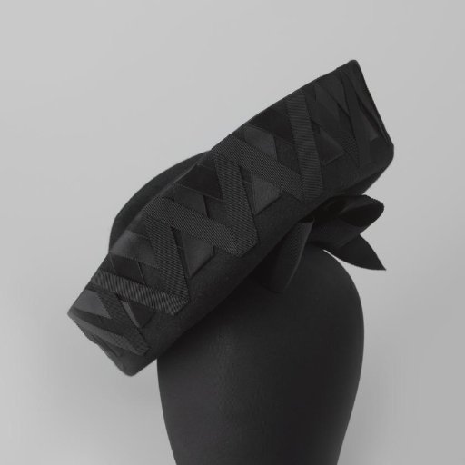 Hat of black felt with wide upturned brim, decorated with diagonally placed ribbons of grosgrain and satin