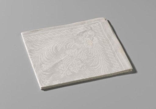 Linen damask napkin with a design of leaf and vine tendrils