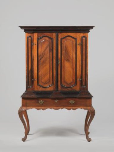 Two-door cabinet on a stand of padouk and ironwood