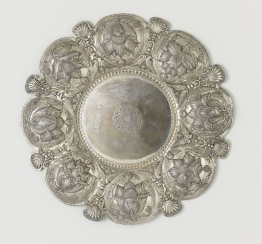 Silver bowl with eight lobes, alternated with shells and birds and a child's head. Chased with flowers.