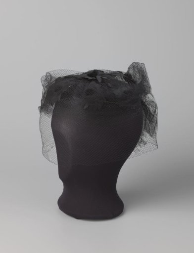 Hairnet of black tulle with appliqué of black flowers