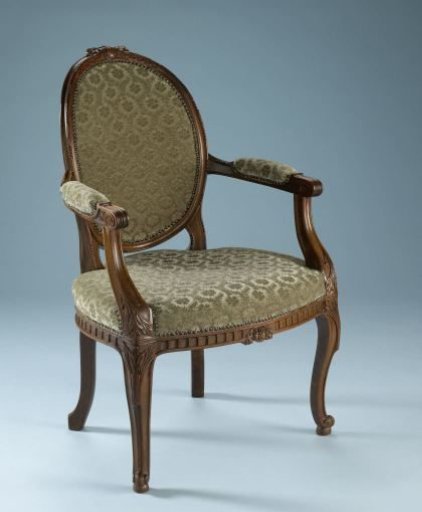 Armchair with a profile-cut female head in the backrest cap within a medallion, flanked by laurel wreaths