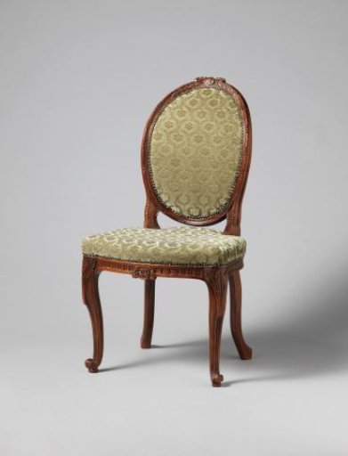 Chair with a profile-cut female head in the backrest cap within a medallion, flanked by laurel wreaths