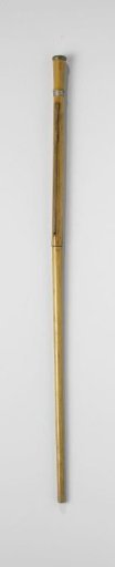 Walking stick of varnished wood with a flat copper knob, containing a rolled-up map of Paris