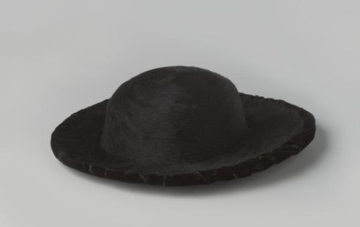 Lady's hat with a ball of black hair felt and a brim of the same felt and black velvet