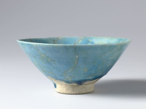 Bowl with a turquoise glaze and stylized flower sprays