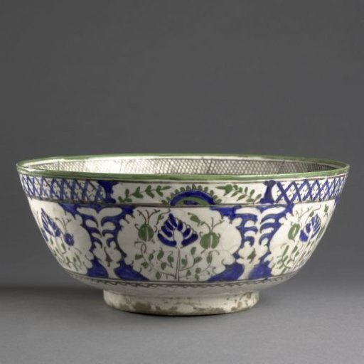 Bowl with a peacock, flowering plant and inscription