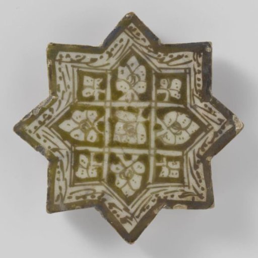 Star-shaped tile with flower sprays and an inscription