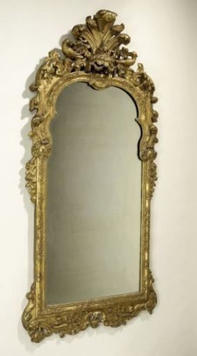 Mirror in a frame of gilded lime wood with a lambrequin at the top, flanked by birds and surrounded by flowers