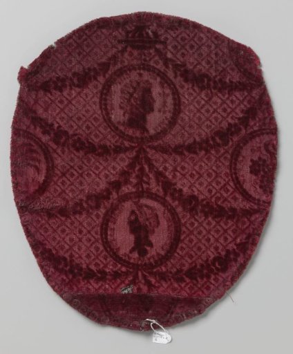 Oval chair upholstery of red sheared and pressed velvet with garlands and medallions filled with antique imperial heads on the background of a grid pattern