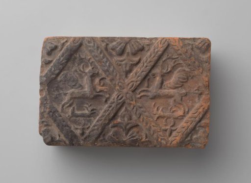 Fireplace surround with a depiction of two flying stags