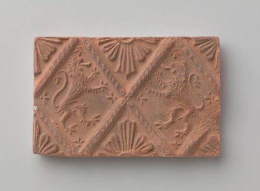 Fireplace stone with a depiction of two climbing lions