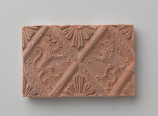 Fireplace stone with a depiction of two climbing lions