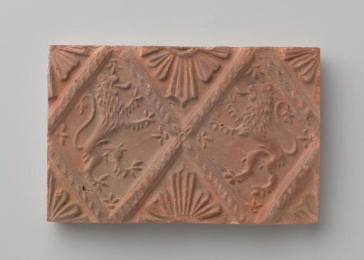 Fireplace stone with depiction of two climbing lions