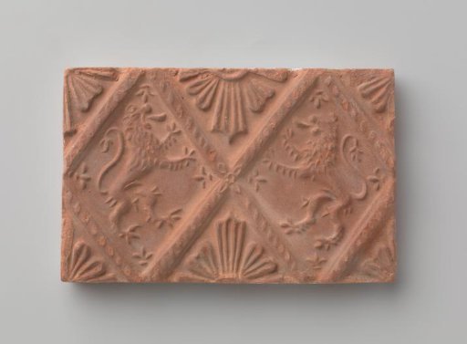 Fireplace surround with a depiction of two climbing lions