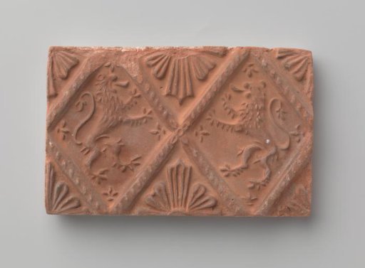 Fireplace surround with a depiction of two climbing lions