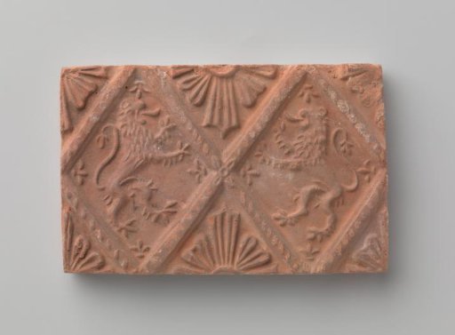 Fireplace surround with a depiction of two climbing lions