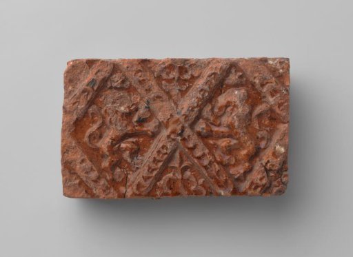 Fireplace surround with a depiction of two climbing lions