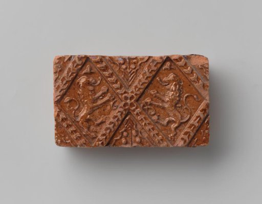 Fireplace surround with a depiction of two climbing lions