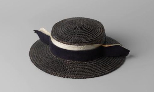 Hat of black straw, decorated with white grosgrain ribbon and black felt