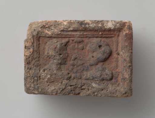 Fireplace with a depiction of a man's and a woman's head in profile, separated by a flowering plant