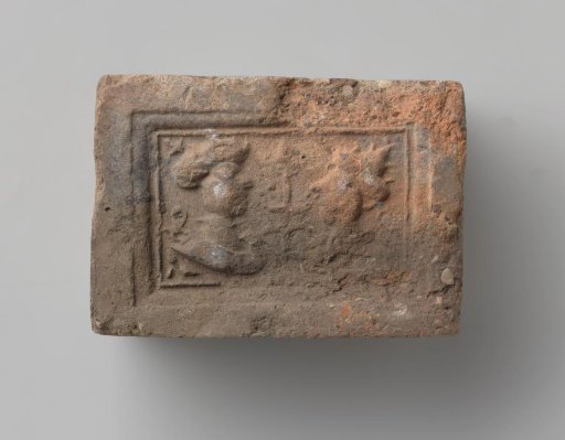 Fireplace with a depiction of a man's and a woman's head in profile, separated by a flowering plant