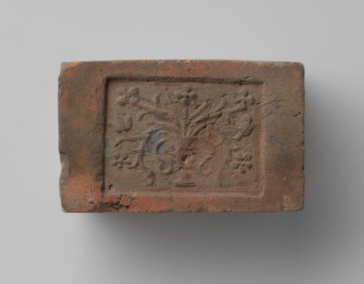 Fireplace with a depiction of a vase with flowers