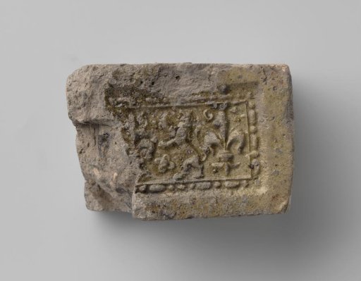 Fireplace with a Climbing Lion Flanked by Two French Lilies