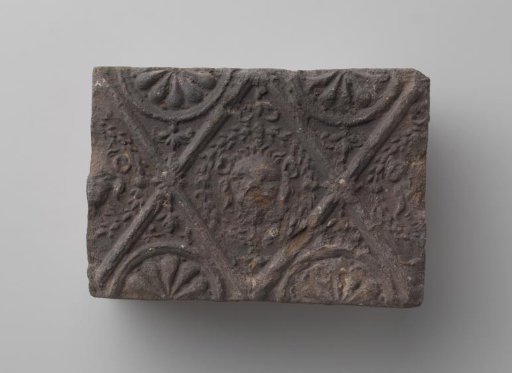 Fireplace with Lion's Head in a Profiled Diamond