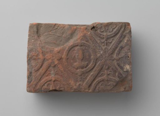 Fireplace with a man's head and the letters V I in a laurel wreath