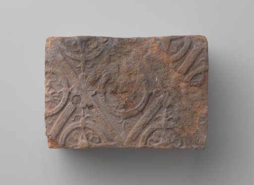 Fireplace mantel with a man's head and the letters V I in a laurel wreath