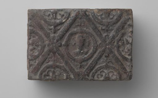 Fireplace mantel with a man's head and the letters V I in a laurel wreath