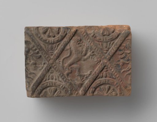 Fireplace surround with a depiction of a climbing lion