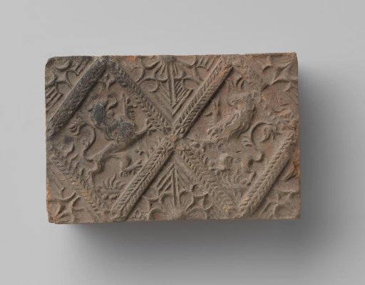 Fireplace surround with a depiction of two climbing lions