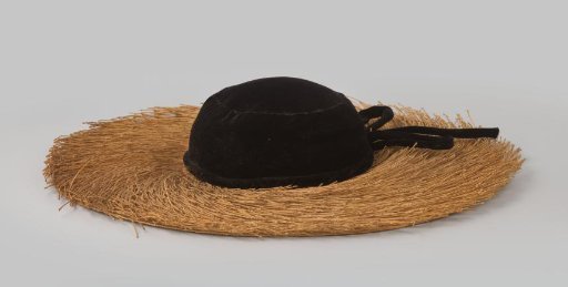 Hat with a low black velvet crown and a wide braided straw brim