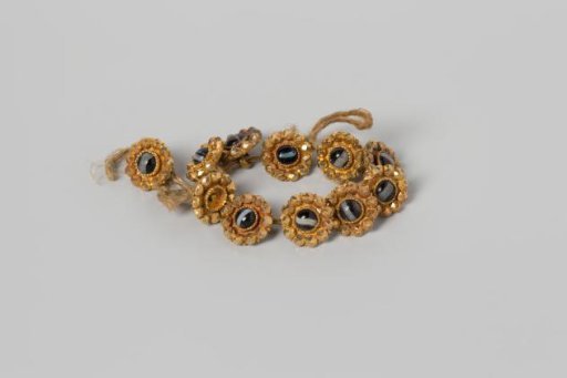 Buttons, eleven pieces on a string