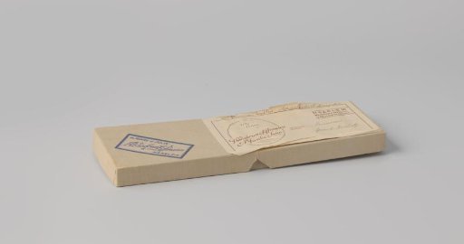 Rectangular cardboard glove box with loose lid; covered with beige paper