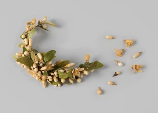 Bridal crown consisting of a semicircular frame decorated with leaves of textile and orange blossoms of wax