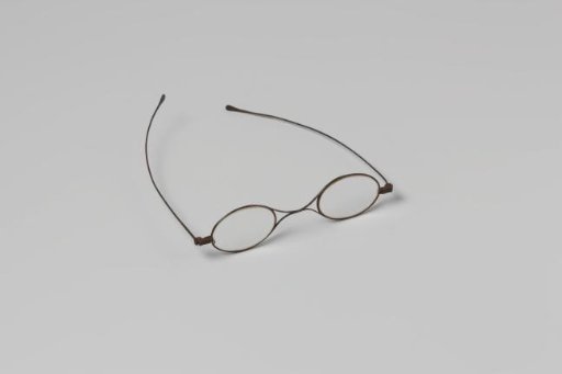 Spectacles with narrow iron frame, oval lenses, double bridge and long straight arms in a cigar box