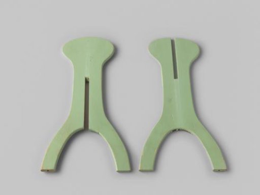 Hat stand, composed of two interlocking light green planks
