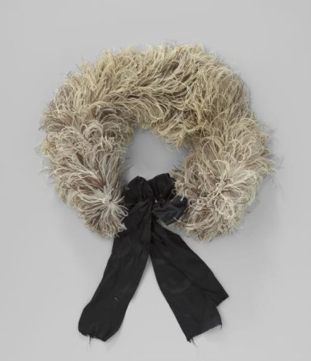 Boa of ostrich feathers, brown and white mottled, with a black bow with snap button