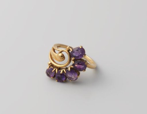 Gold ring with five amethysts in a box with lid