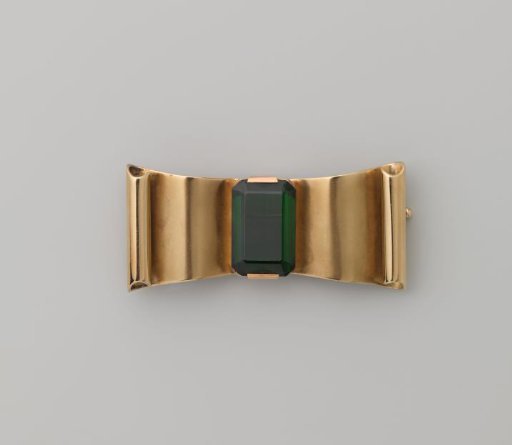 Bow brooch of gold with deep green synthetic spinel in a box with lid